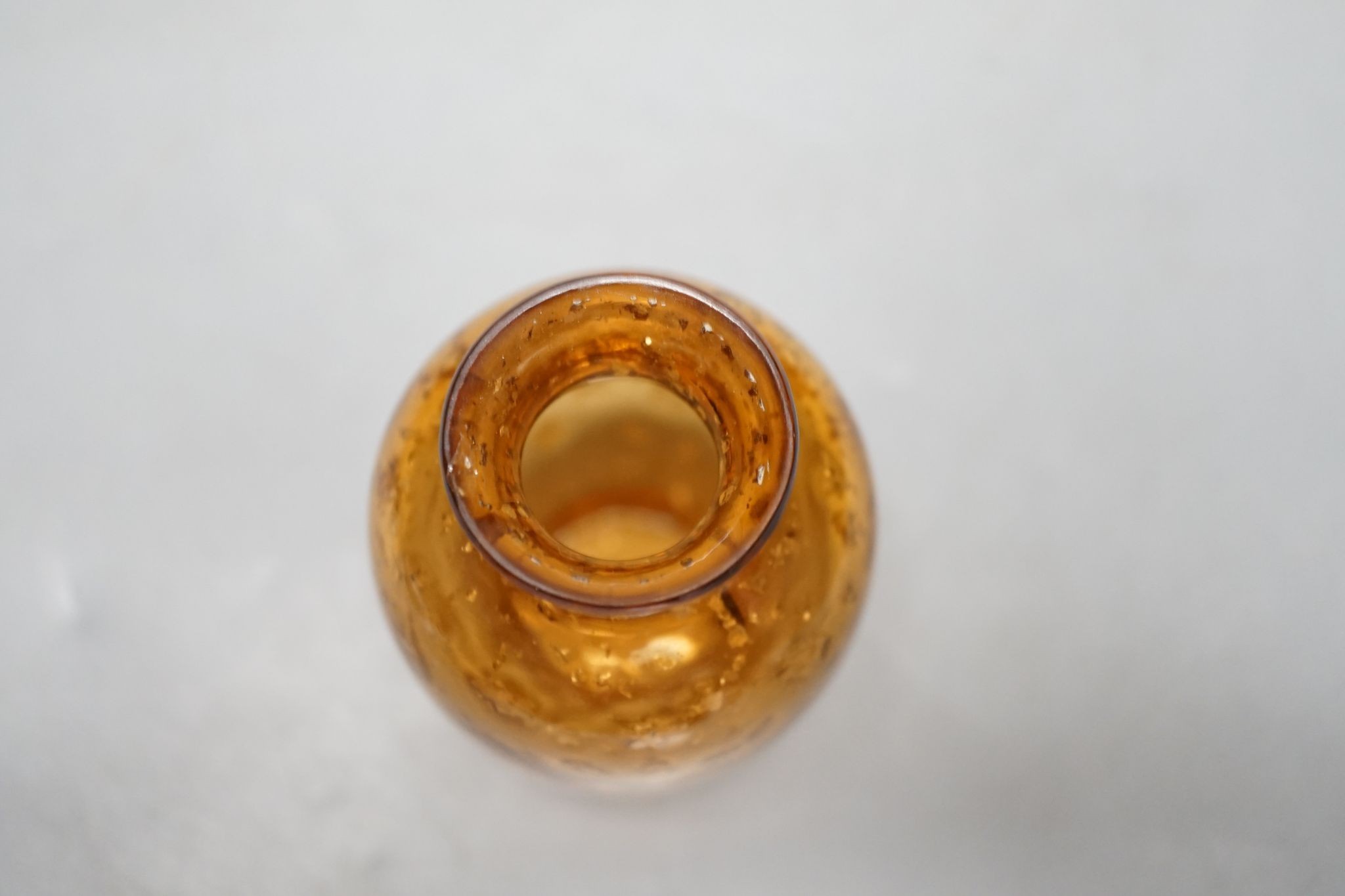 A Chinese gilt included amber glass vase., 9 cms high.
